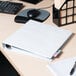 A white Avery heavy-duty view binder sitting on a desk.