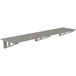 A long stainless steel slotted wall shelf.