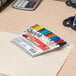 A desk with a group of Sharpie colored markers on it.