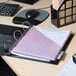 A black Avery Heavy-Duty View Binder on a table with a black keyboard and a black computer mouse.