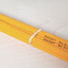 A group of yellow pencils tied with a beige Universal rubber band.