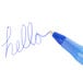 A close-up of a Bic blue medium point pen writing "hello" in blue ink.