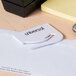 A white plastic Universal letter slitter with black text on it.