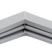 A close-up of a gray metal corner piece of a Traulsen 341-60176-03 equivalent magnetic drawer gasket.