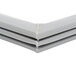 A close up of a gray corner piece of a Traulsen magnetic door gasket.