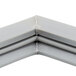 A close up of a gray corner piece of a Traulsen magnetic door gasket.