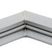 A close up of a gray corner piece of a Traulsen magnetic door gasket.