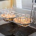 A Tablecraft double taco cup fry basket on a counter.