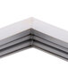 A close up of a white metal corner of a Traulsen equivalent magnetic door gasket.