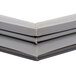 A close up of a gray plastic corner on a white background.