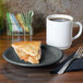 A Fiesta Slate China appetizer plate with a slice of pie on it next to a white mug of coffee.