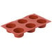 A red silicone Matfer Bourgeat muffin mold with six cups.