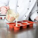 A chef pouring batter into a Matfer Bourgeat muffin pan.