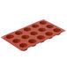 A red silicone round petit fours mold with 15 compartments.