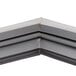 A close up of a gray corner piece for a Traulsen refrigerator door.