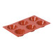 A red silicone baking pan with six Tatin molds.