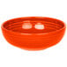 A white china bistro bowl with an orange interior and rim.