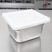 A stainless steel Vollrath Super Pan V 1/6 size container with a flexible metal lid.