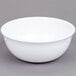 A white bowl on a gray surface.