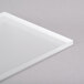 A white rectangular acrylic buffet shelf on a gray surface.