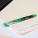 A green Sharpie liquid highlighter marking a file.