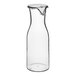 A clear polycarbonate decanter with a lid.