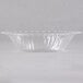 A clear plastic Fineline Flairware bowl with a ruffled edge.