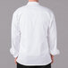 A man wearing a white Mercer Culinary chef jacket with long sleeves.