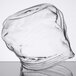 An American Metalcraft clear glass zipper bag on a table.