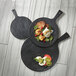 An American Metalcraft black faux slate melamine serving peel with food on black plates.