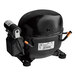 A black Traulsen refrigeration compressor with a white label.