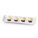 A white GET rectangular melamine tray with three cupcakes with white frosting on it.