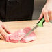 a person cutting meat with a knife