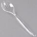 A clear plastic serving fork with curved tines.
