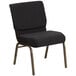 A black church chair with gold dots on the backrest.