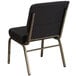 A black church chair with gold legs and a polka dot pattern.