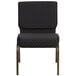 A black church chair with gold legs and a polka dot pattern.