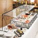 An Aqua Cal-Mil portable sneeze guard on a hotel buffet table with a variety of food on it.