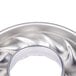 A silver metal Gobel Trois Freres mold with a curved edge and spiral design.