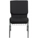 A black Flash Furniture church chair with metal legs.