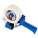 A Shurtape standard pistol grip packaging tape dispenser with a blue handle.