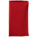 A folded red Intedge cloth napkin.