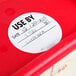 A roll of white National Checking Company Use By labels with a red and black print.
