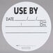 A roll of white National Checking Company stickers with black text that reads "Use By" and a white circle.