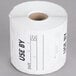 A roll of white paper National Checking Company Use By labels with black text.