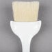 a white brush with a handle