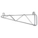 An Advance Tabco metal shelf with a double metal wall mounting bracket.