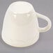 A CAC ivory china espresso cup with a scalloped edge and gold accent band.