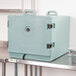 A blue Cambro insulated tray carrier with black handles on a metal shelf.