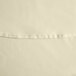 A close up of an ivory fabric table cover with a hemmed edge.